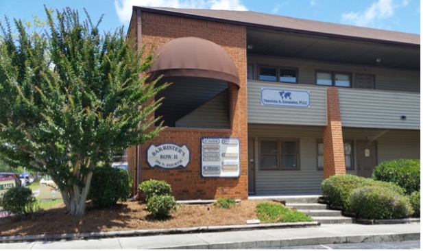 Brick building with professional offices and landscaped front.