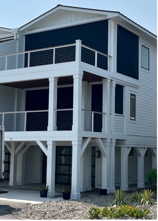 Modern two-story beach house with balconies.