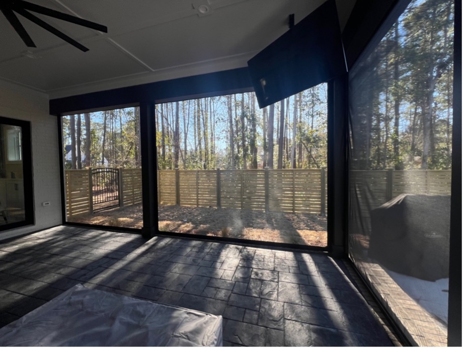 Sunlit screened patio with forest view