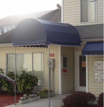 Blue awnings over residential entrance with mailbox.