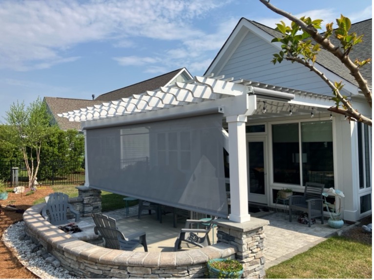 Backyard patio with pergola and retractable screen.