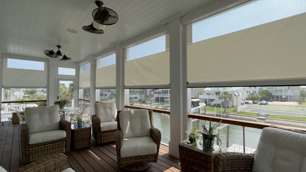 Outdoor patio with wicker chairs and water view.