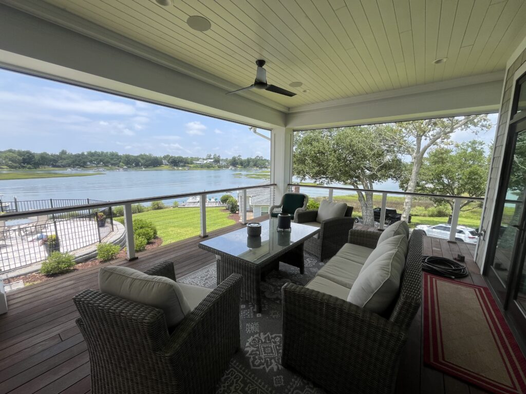 Covered patio overlooking scenic lake view.