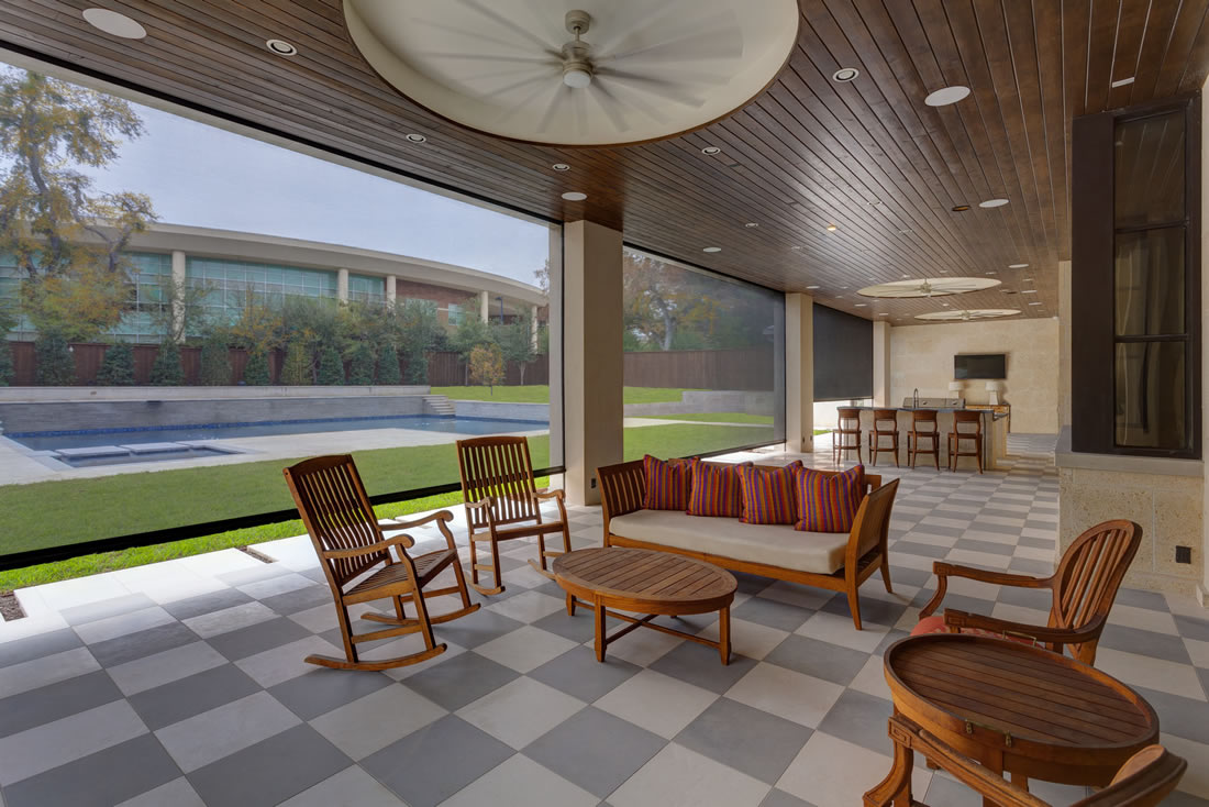 Modern patio with pool view and seating area.