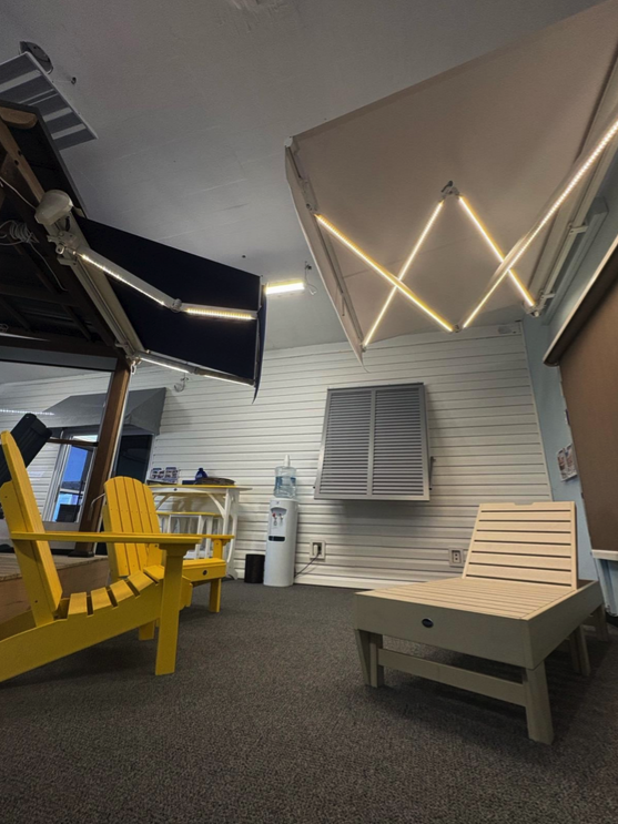 Indoor display of awnings, chairs, and water cooler.