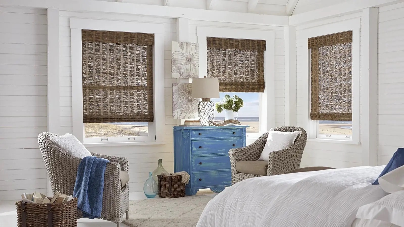 Cozy beach-themed bedroom with wicker furniture.